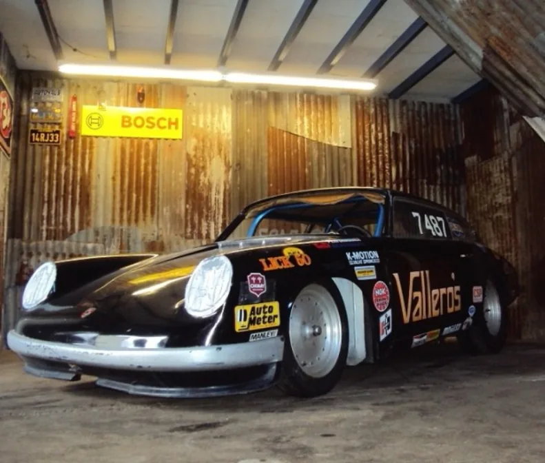 Ray Vallero's 912-bodied Volkswagen drag car in Vallero's livery, parked in a corrugated iron shed