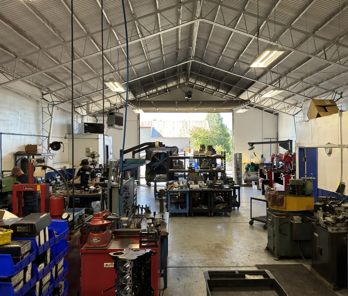 The RVJ Machine shop floor in Auburn, California, with Sunnen honing machines, benches and racked cylinder heads