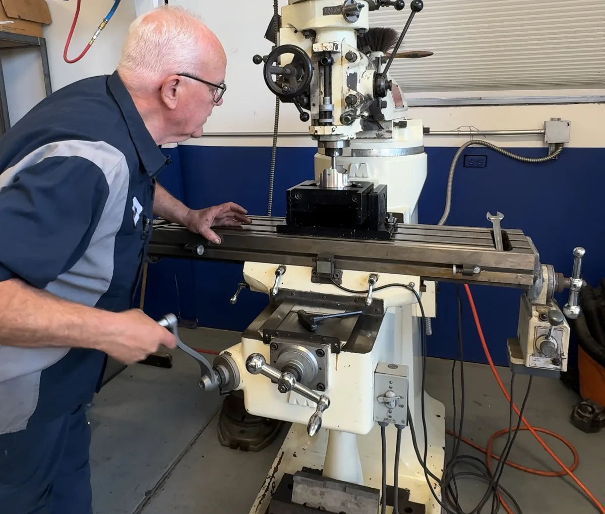 Vernon "Buddy" Johnson, the J in RVJ, working at the Comet milling machine on the shop floor