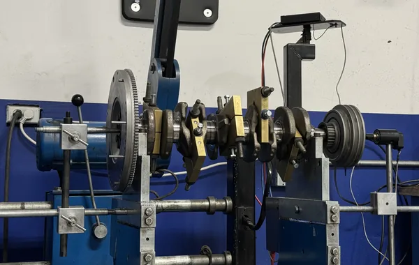 A crankshaft set up with flywheel and harmonic damper on the engine balancing machine