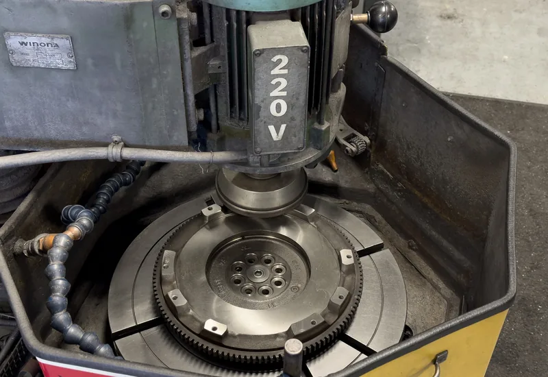 A flywheel being resurfaced on the Winona FG-5000 flywheel grinder at RVJ Machine