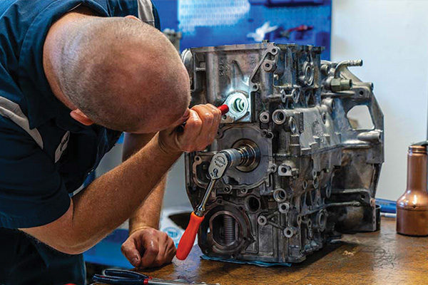 Technician inspecting an engine block